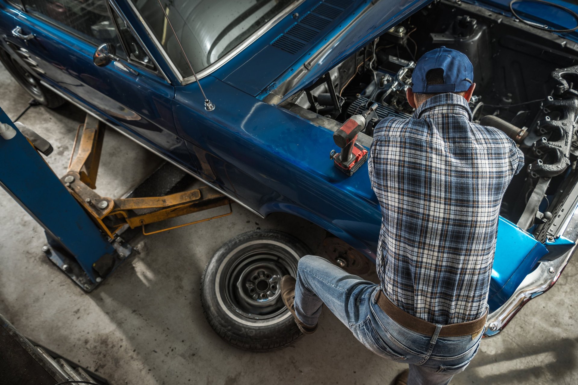 Classic car mechanic performing engine restoration