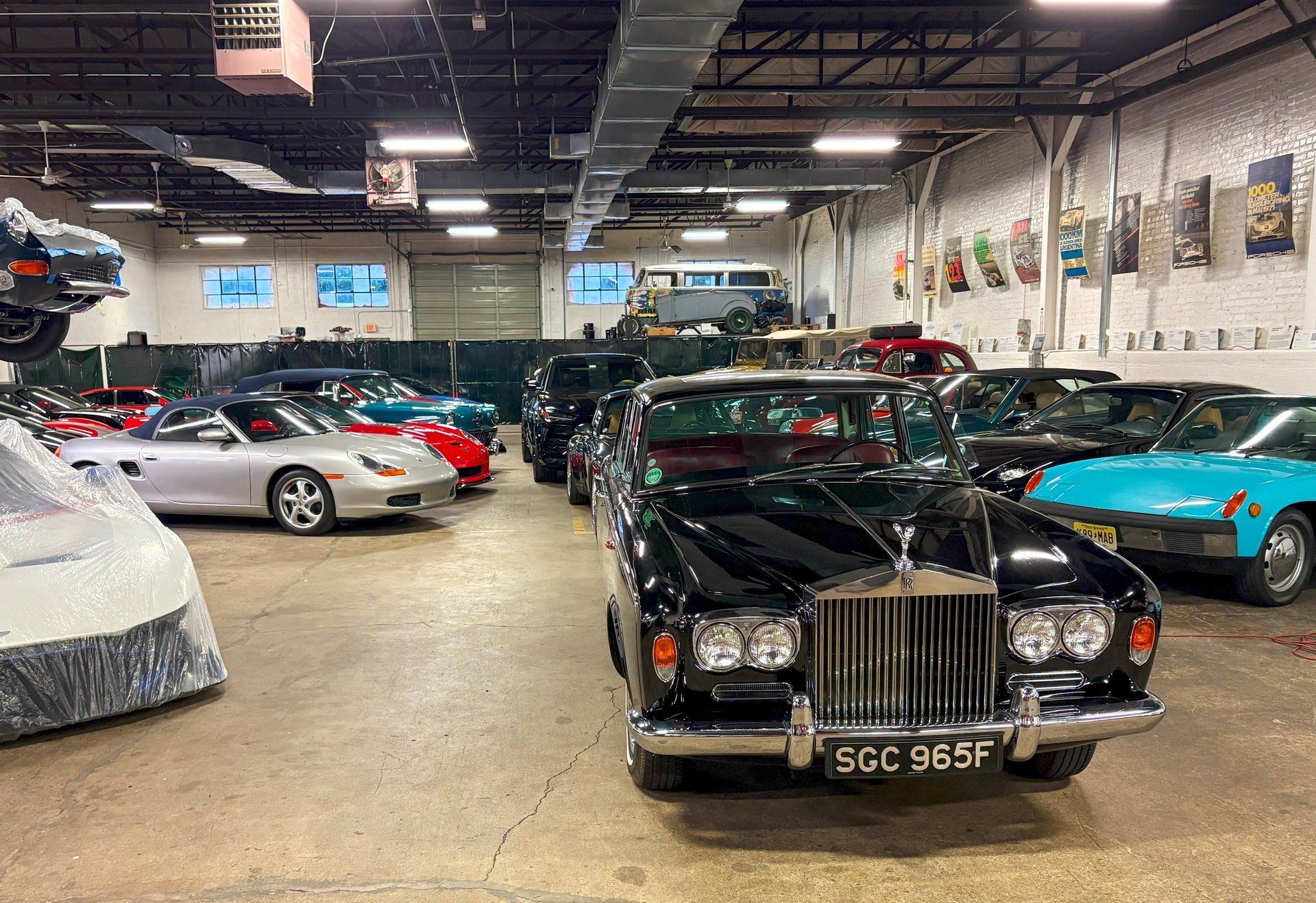 Numerous vintage and classic cars arranged in an expansive garage