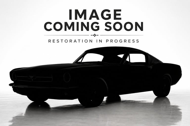 Silhouette of a classic vintage car positioned in profile against a light background with restoration in progress text overlay